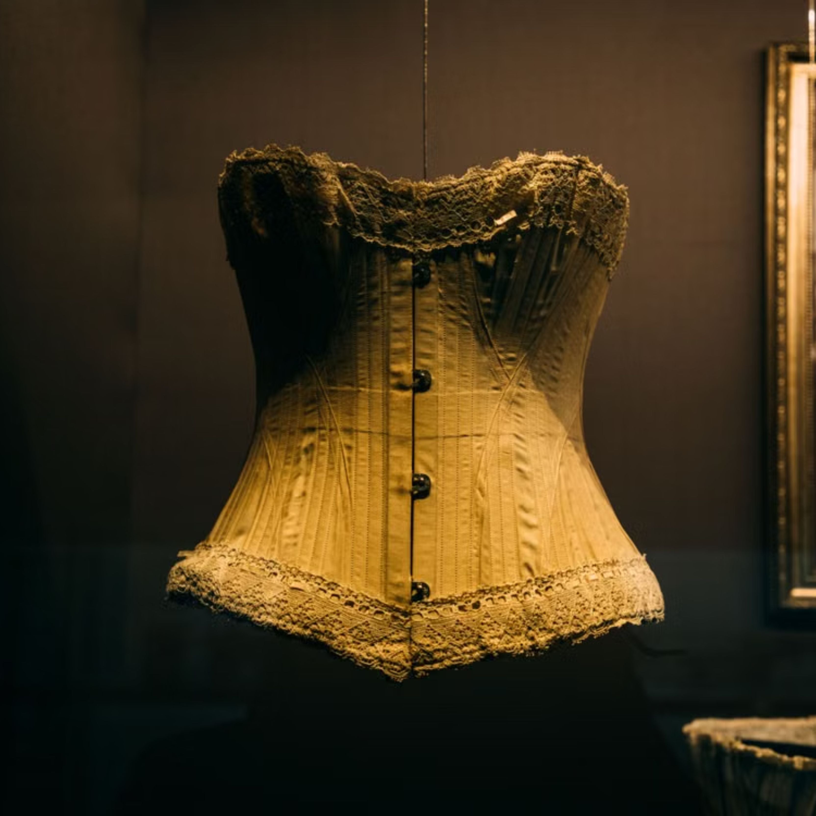 Historic corset displayed in a fashion museum, preserving garment construction and craftsmanship.